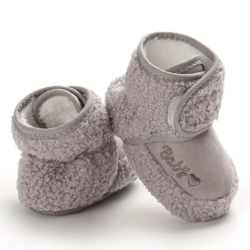 Cozy boots for baby boys and girls, featuring hook and loop fasteners for indoor and outdoor winter walks.