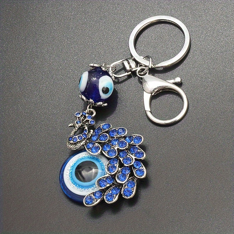 Blue Evil Eye Keychain with Rhinestone Inlaid Peacock Design, made from Alloy, Perfect for Women's Daily Use as a Trendy Hanging Pendant or Bag Charm.