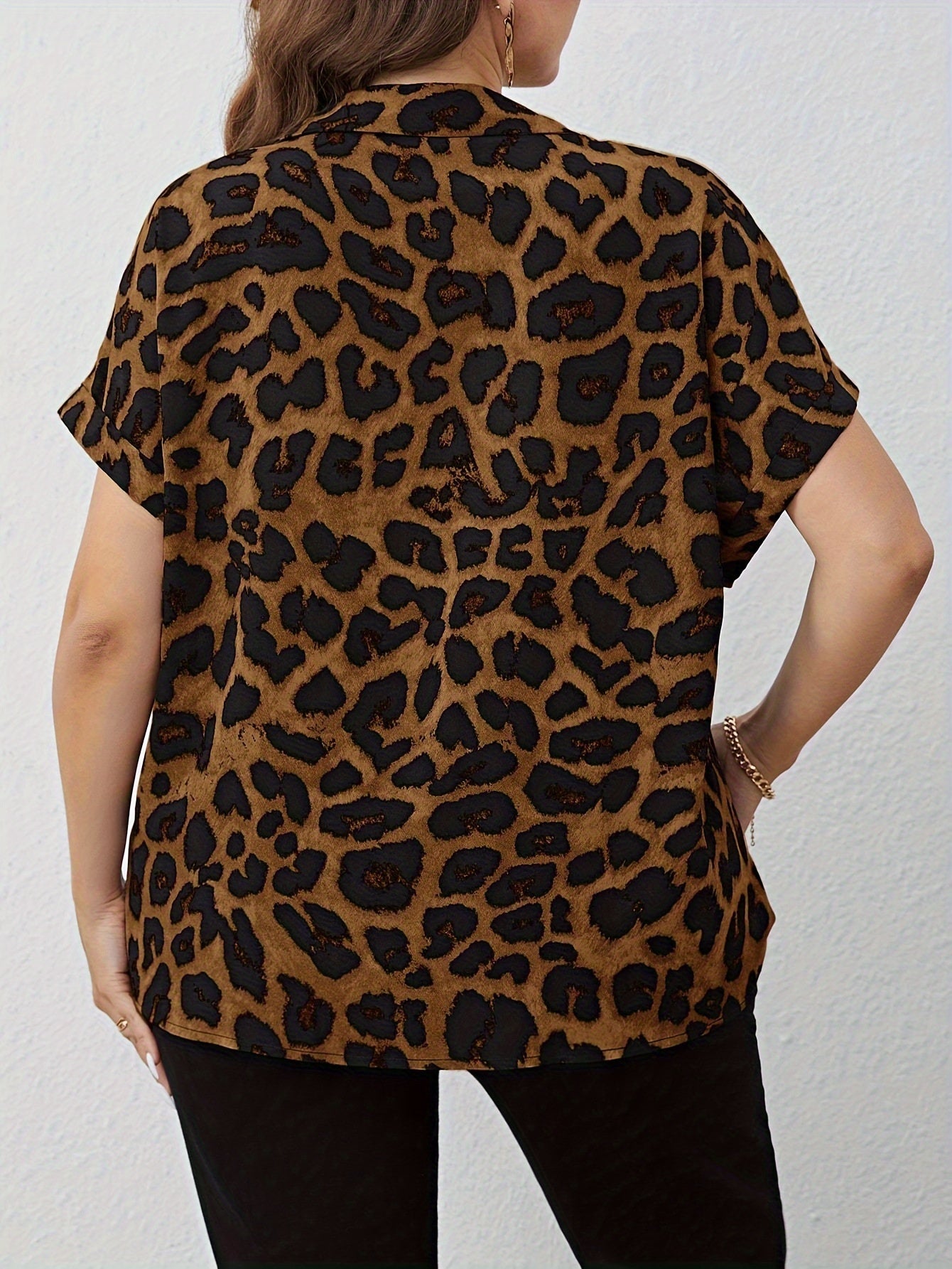 Leopard print V-neck batwing sleeve shirt for plus size women, perfect for casual or work wear. Made of machine washable polyester fabric, suitable for all-season wear.