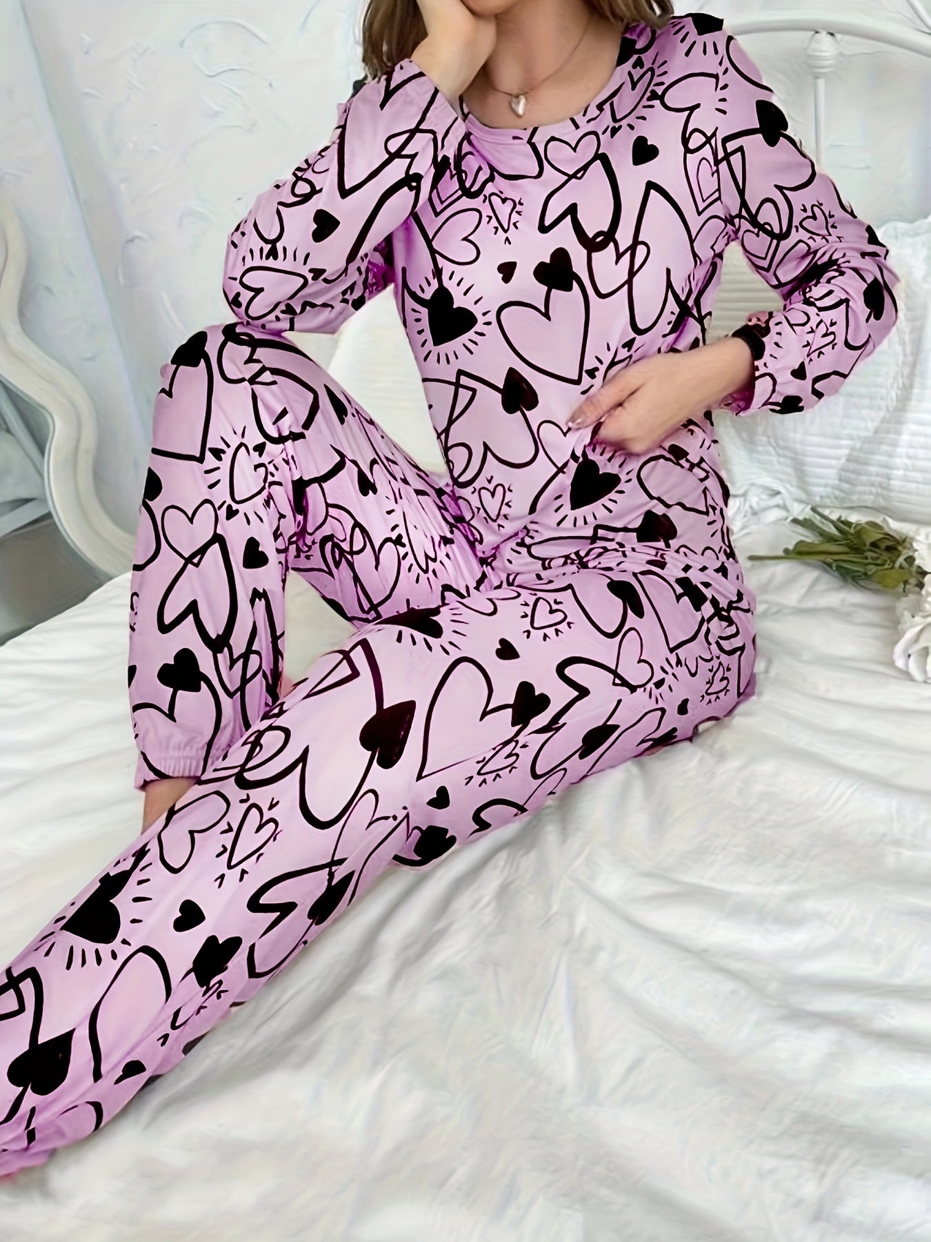 Women's lounge set with heart print, long sleeve top, crew neck, and elastic waistband pants for loungewear and sleepwear.