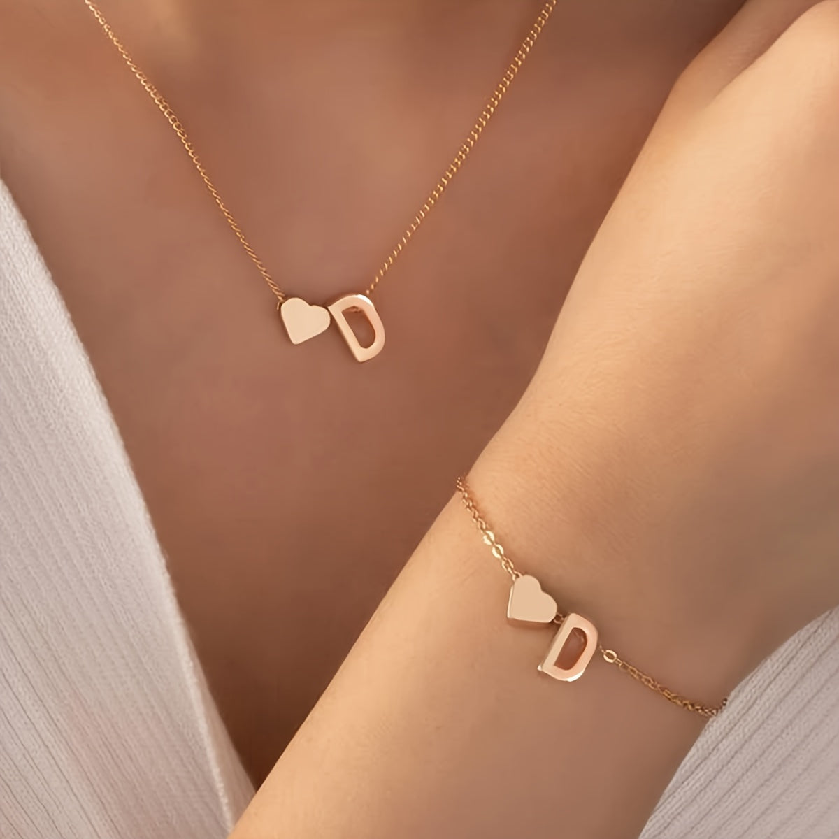 Chic two-piece set with metal heart and letter necklace and bracelet, ideal for daily wear.