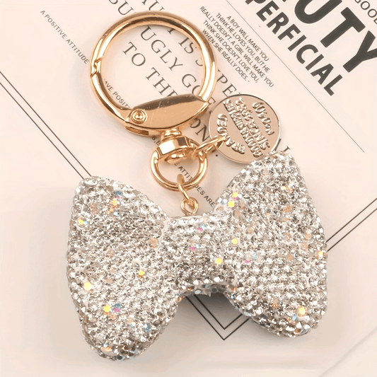 Golden spring ring metal keychain adorned with a new rhinestone bow design, ideal for accessorizing women's bags or as a car ornament.