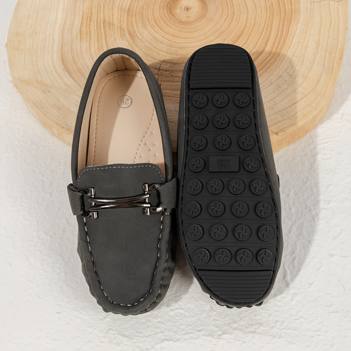 Boys' slip-on loafers in black and brown, suitable for all activities.