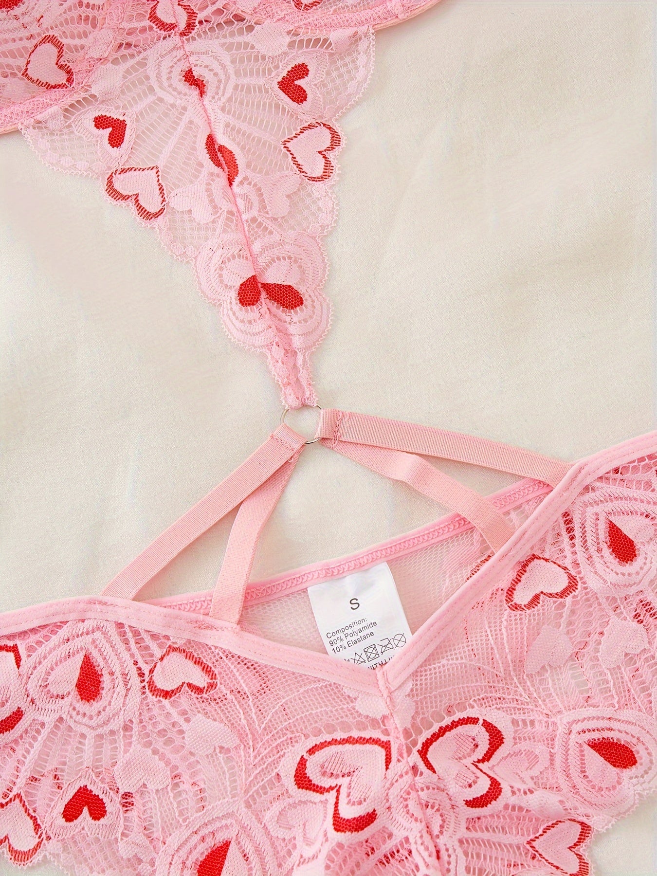 Pink heart-embroidered adult lingerie set made from polyamide and elastane blend, suitable for adults.