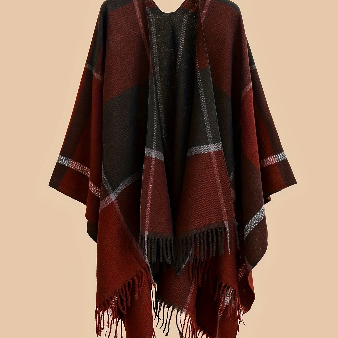 Stylish plus size shawl cardigan with tassels for fall/winter parties features v-neck, asymmetrical hem, and geometric pattern.