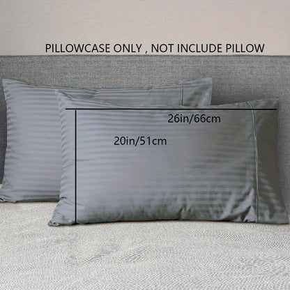 A pair of striped pillowcases made from soft, breathable woven polyester. These pillowcases are machine washable and have a sanded finish for added comfort. They do not include a pillow insert and are made from non-printed lightweight fabric with a 90gsm