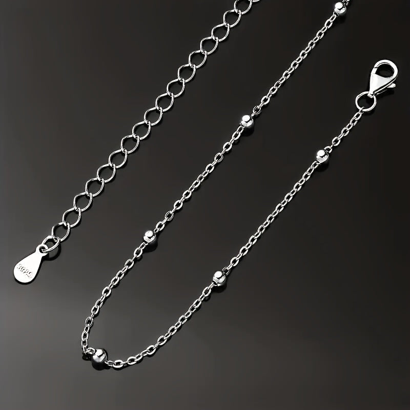 An elegant 925 silver necklace featuring 2 grams of shimmering beads, a delicate collarbone chain, and a stylish piece of jewelry designed for women.