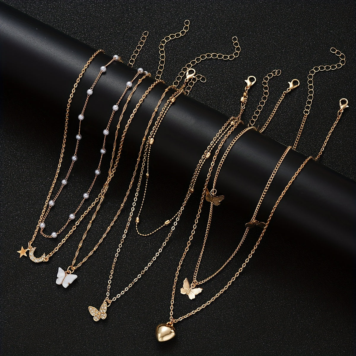 Set of 11 pieces featuring faux pearl and rhinestone star, butterfly, and heart necklaces for women. This fashion stacking jewelry set is perfect for daily wear, dates, holidays, and parties. Ideal for adding a simple and vacation style to any outfit.