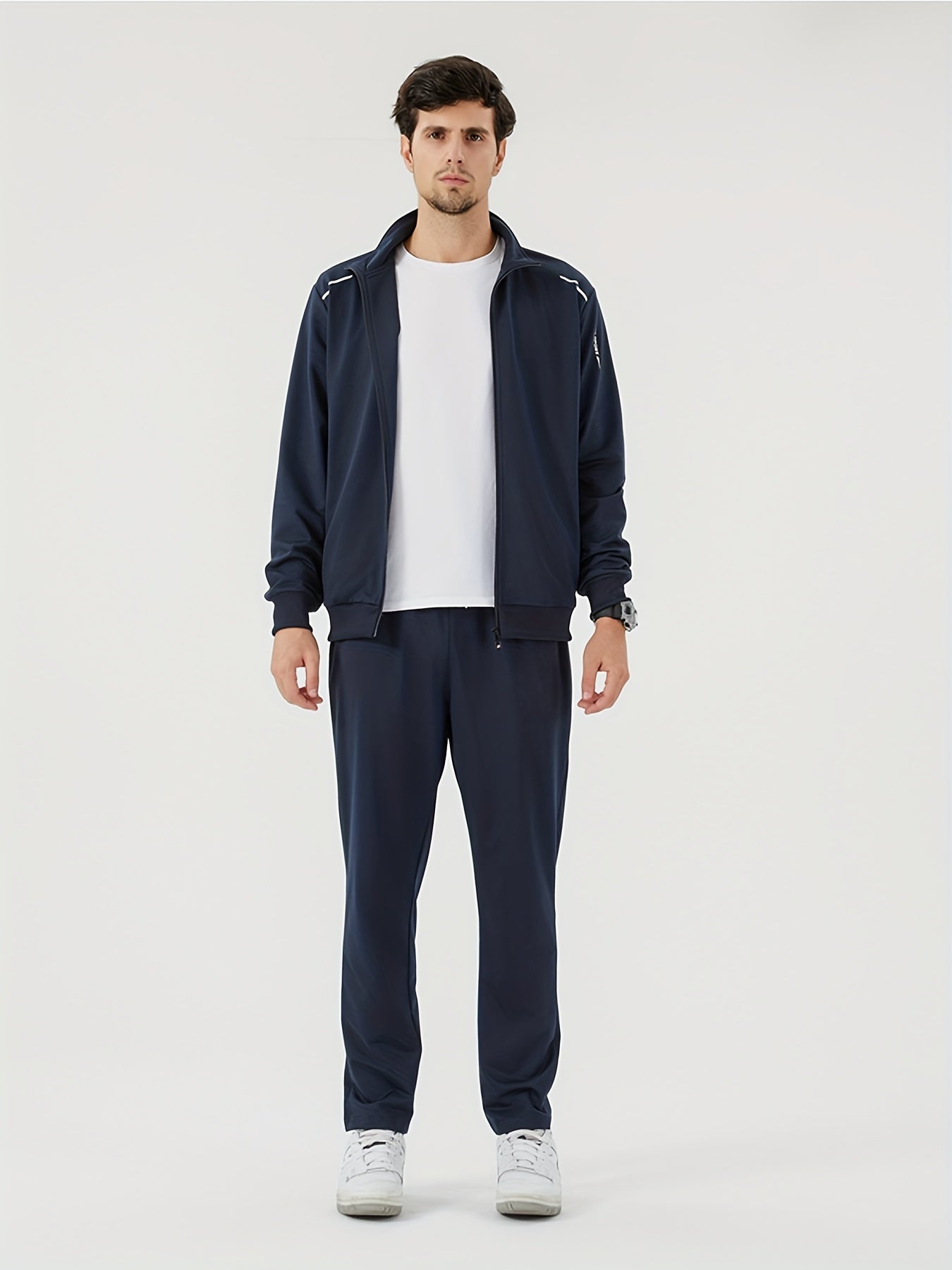 Men's athletic tracksuit with solid color zip-up stand collar jacket and casual loose pants.