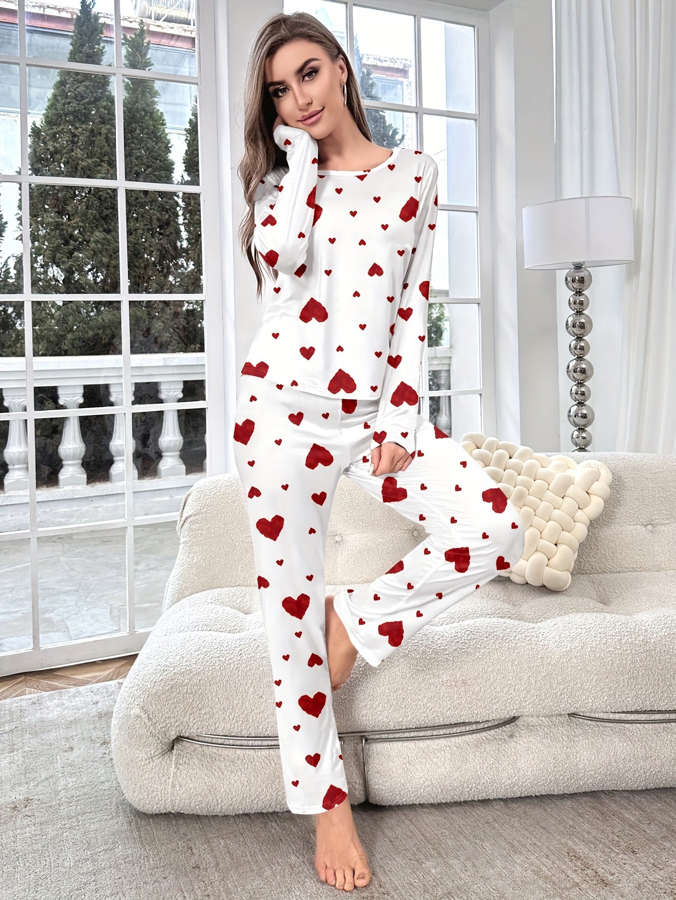 Women's heart print pajama set with round neck and long sleeves. Made from polyester, perfect for cozy home wear in autumn/winter. Includes long pants and pullover.