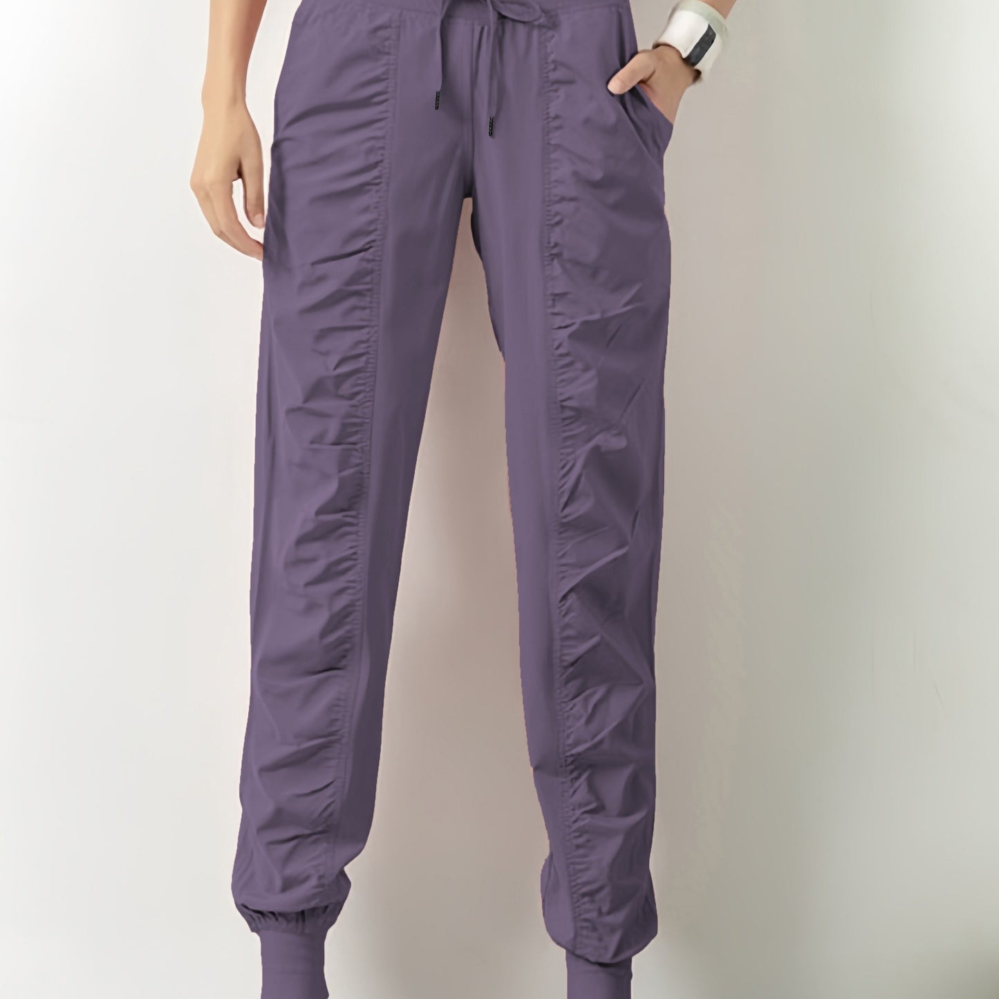 Women's solid color sports pants with drawstring waist, quick drying material, and side pockets for casual comfort.