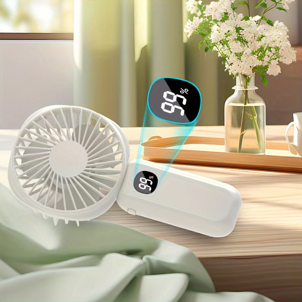 This portable handheld fan features a built-in battery capacity display and can be powered by USB or batteries. It also doubles as a convenient phone holder and is compact and easy to transport. Perfect for both handheld and desktop use, this fan is a