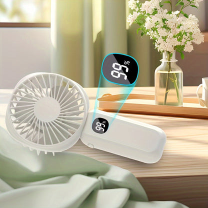 This portable handheld fan features a built-in battery capacity display and can be powered by USB or batteries. It also doubles as a convenient phone holder and is compact and easy to transport. Perfect for both handheld and desktop use, this fan is a