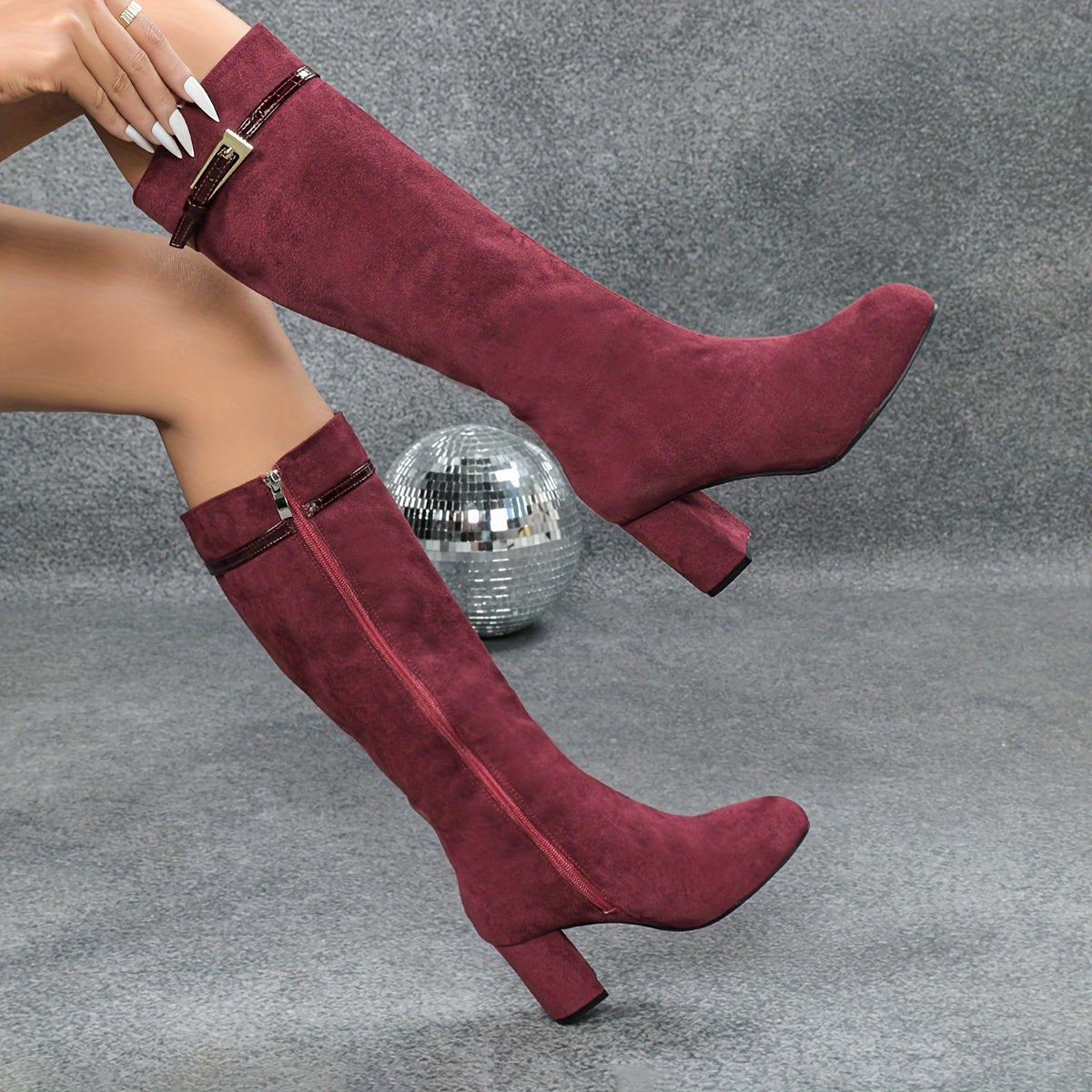 Burgundy side zip round toe knee-high boots with chunky heels.