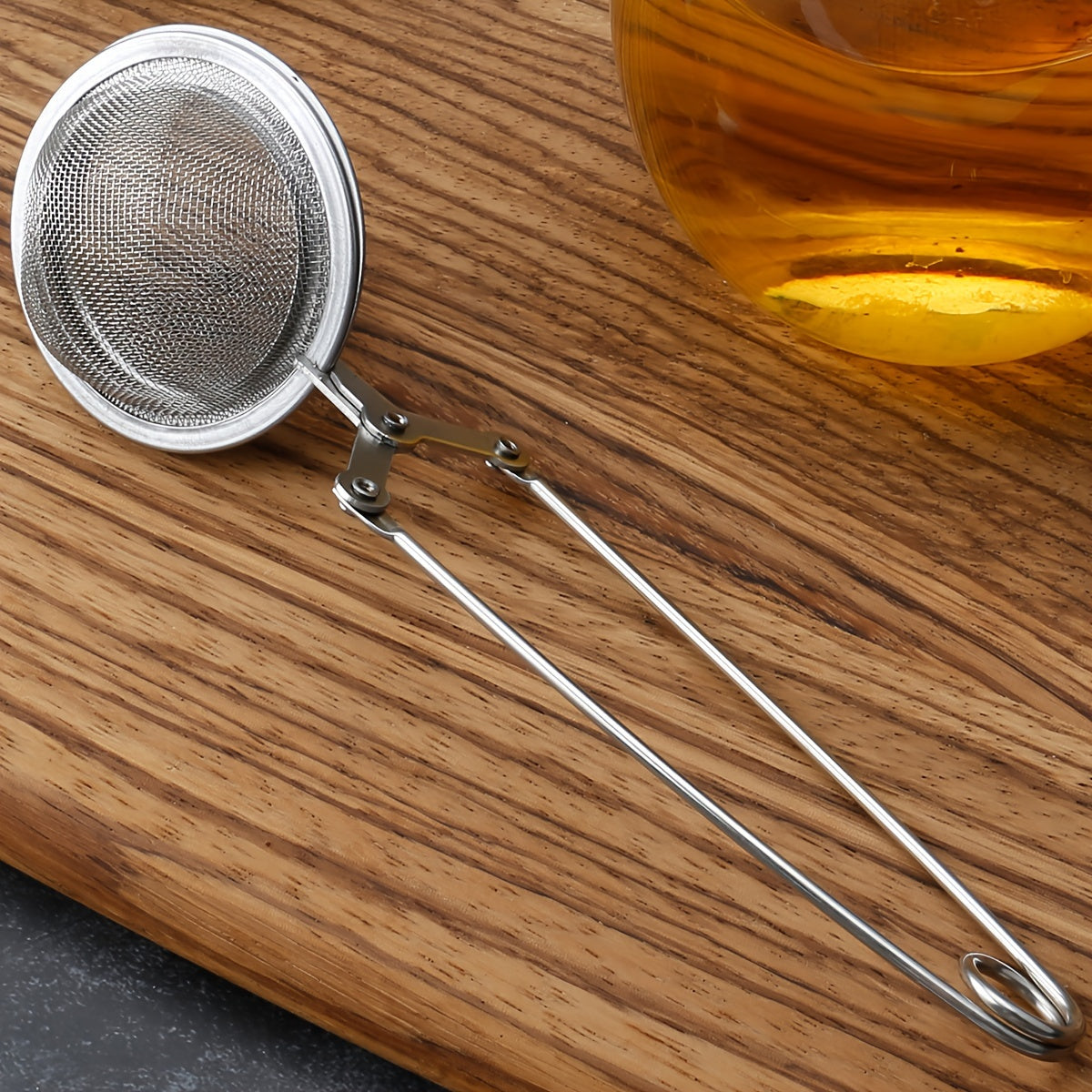 Stainless steel tea filter ball, perfect for making tea, infusing seasoning, spices, and marinades in hot pots.