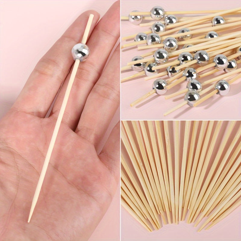 100 pieces of golden, pink, and white pearl bamboo toothpicks for weddings and parties, ideal for appetizers, fruits, and beverages on special occasions. Great for cakes, desserts, and cupcakes.