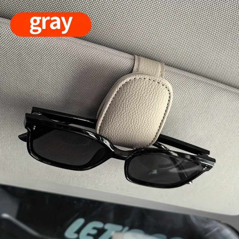 Universal car sun visor clip made of PVC material for storing eyeglasses in the vehicle interior.