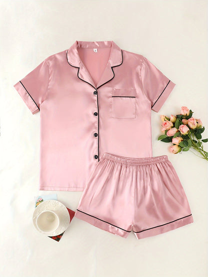 Women's satin pajama set with short-sleeve top and button-up shorts.