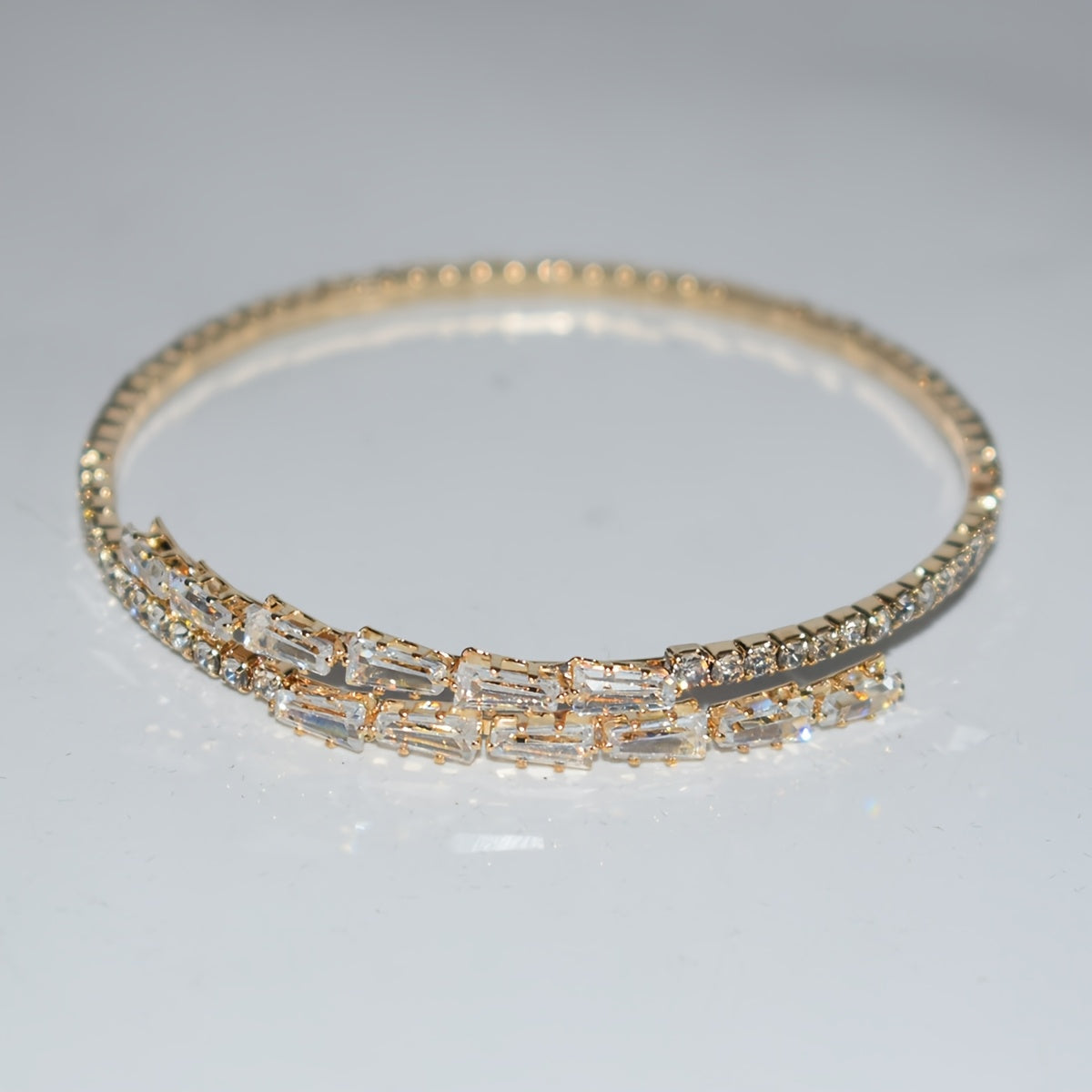 Elegant silvery-plated bracelet with cubic zirconia in classic single row design for weddings and everyday glam.