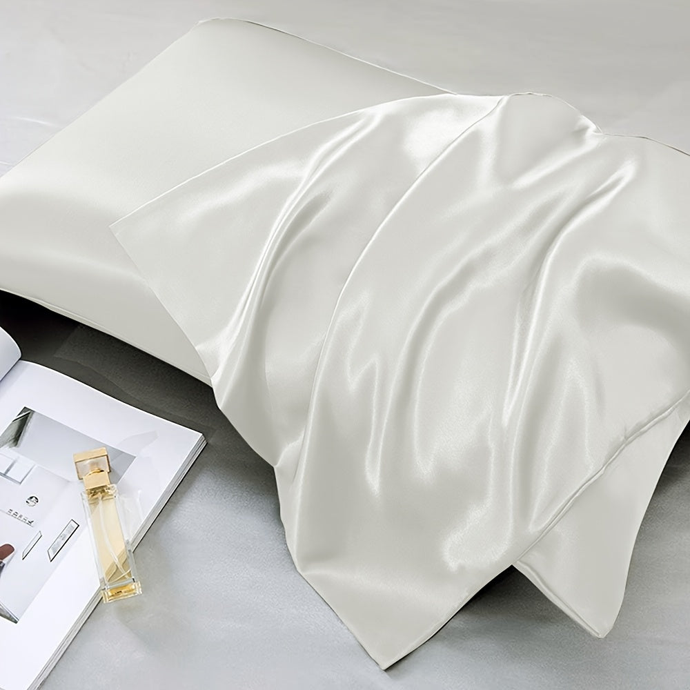 Two-pack of luxurious silky satin pillowcases, made from ultra soft smooth polyester with an envelope closure design. Available in solid colors, these machine washable pillow covers are lightweight at 80-85gsm, providing cooling comfort for hair and