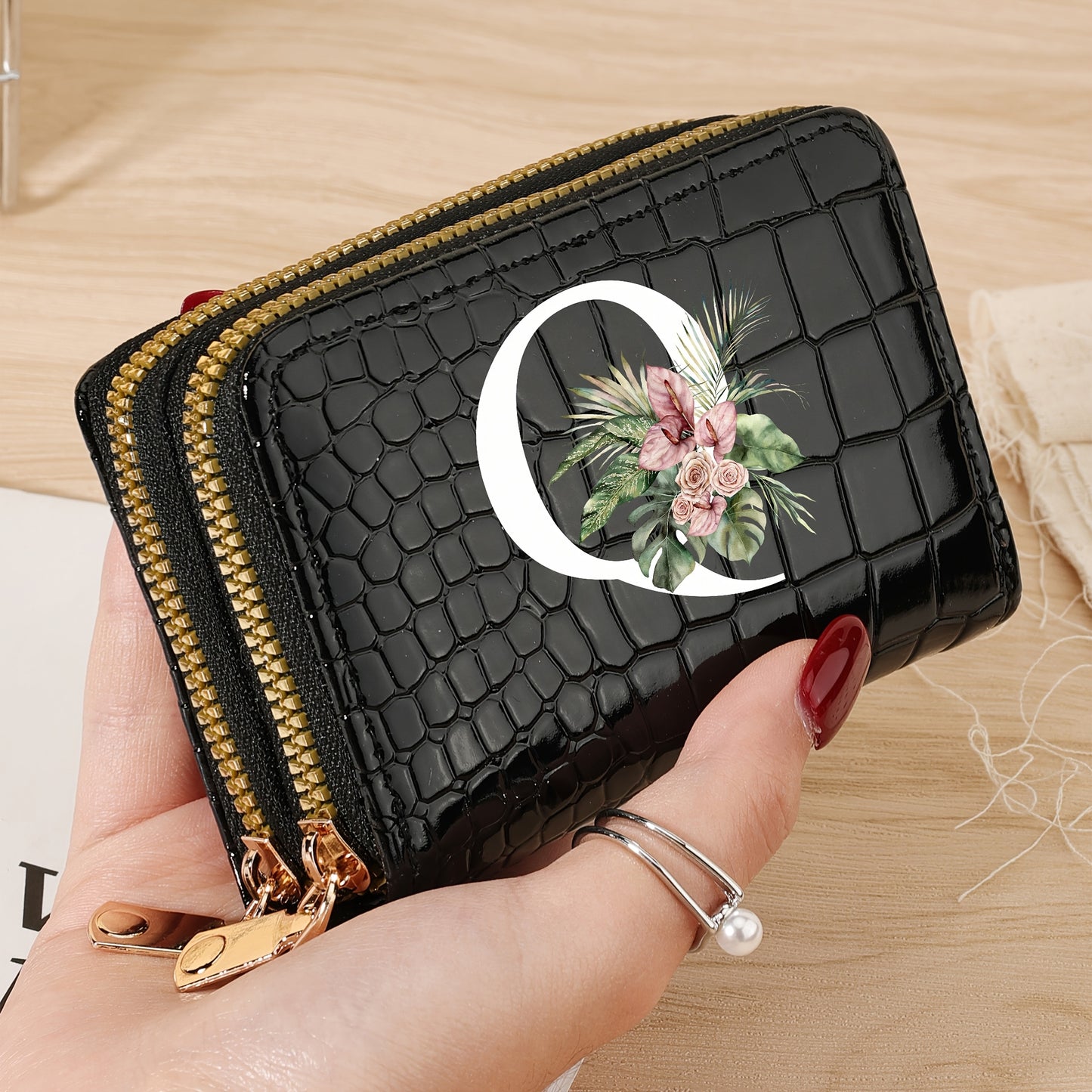 Women's credit card wallet with elegant floral letter print in black & white. Features large capacity, dual zipper, crocodile texture PU, lightweight design with nylon lining for everyday