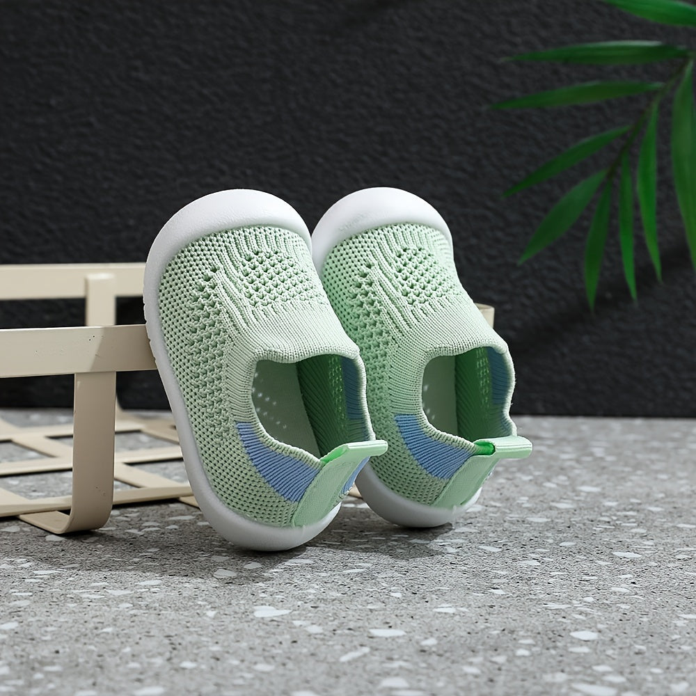 Soft infant walking shoes for toddlers made with knitted fabric.