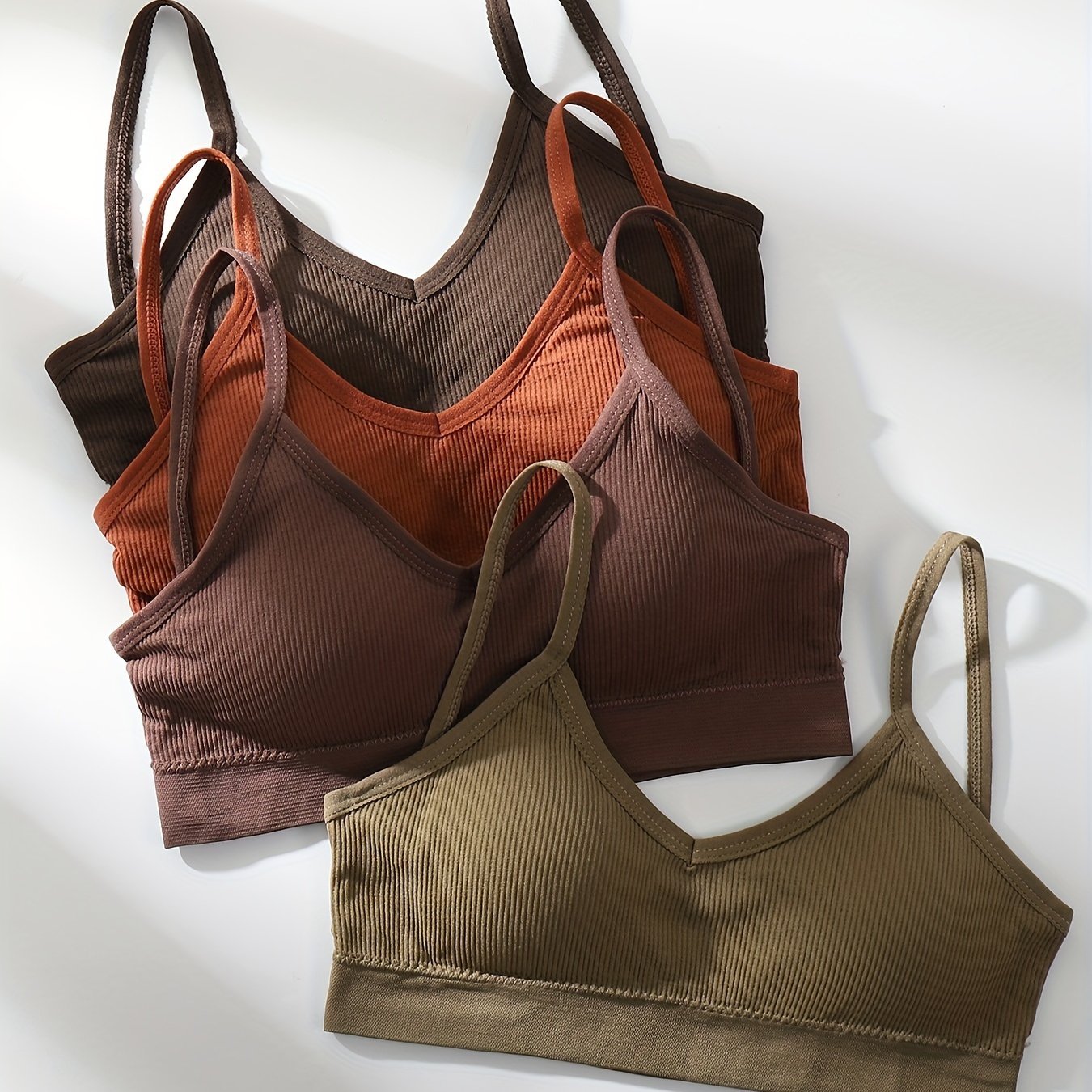 Four wireless bras made of solid ribbed material that are comfortable, breathable, and stretchy. Ideal for women looking for lingerie and underwear.