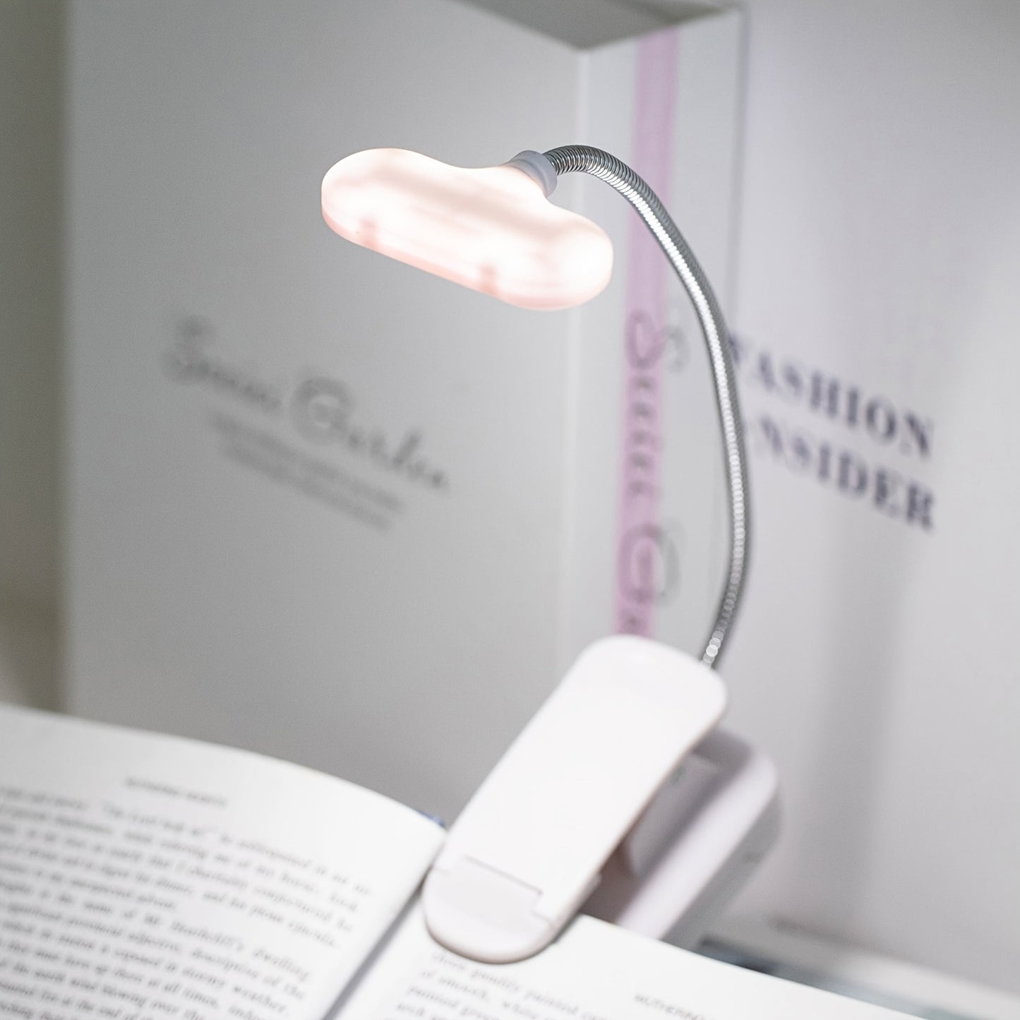 Portable LED book light with adjustable arm, push button control, and polished finish. Battery not included.