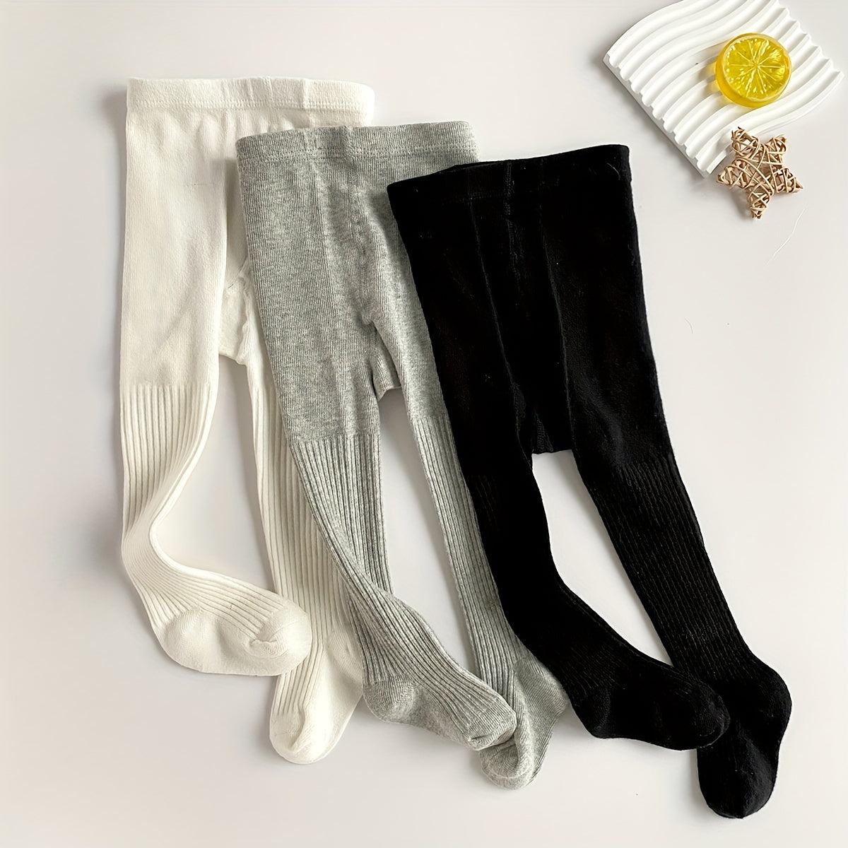 3-pack Soft & Breathable Girls' Leggings Socks in Light Gray, Beige, & Brown. 3.5% Spandex/96.5% Polyester. Sweat-absorbing for year-round wear. Hand wash only. Cute design.