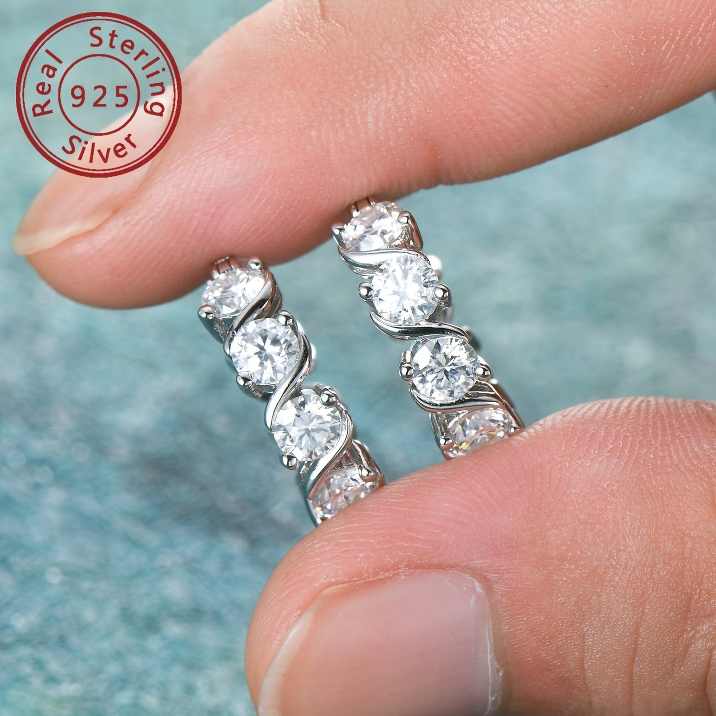 A beautiful pair of Moissanite earrings made with 925 sterling silver. These ladies earrings feature full diamond 4mm round Moissanite stones, with a total of 16 grains on each earring for a total carat weight of 4.8ct. The earrings have a silvery gram