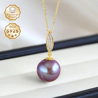 This stunning pendant necklace features a 13-14mm round natural freshwater pearl in an elegant shade of purple. The gemstone may have minor imperfections, adding to its unique beauty. The pendant is crafted from S925 silver and comes with a gift box