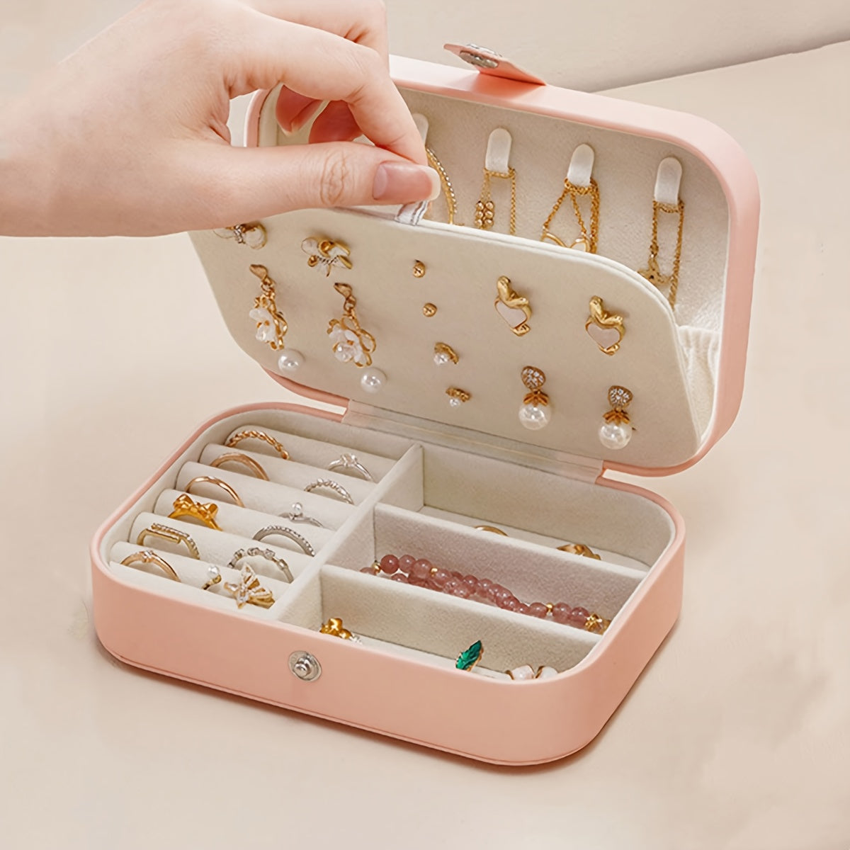 Compact travel jewelry organizer box with removable dividers for rings, earrings, bracelets, and lipstick. Made of contemporary style plastic.