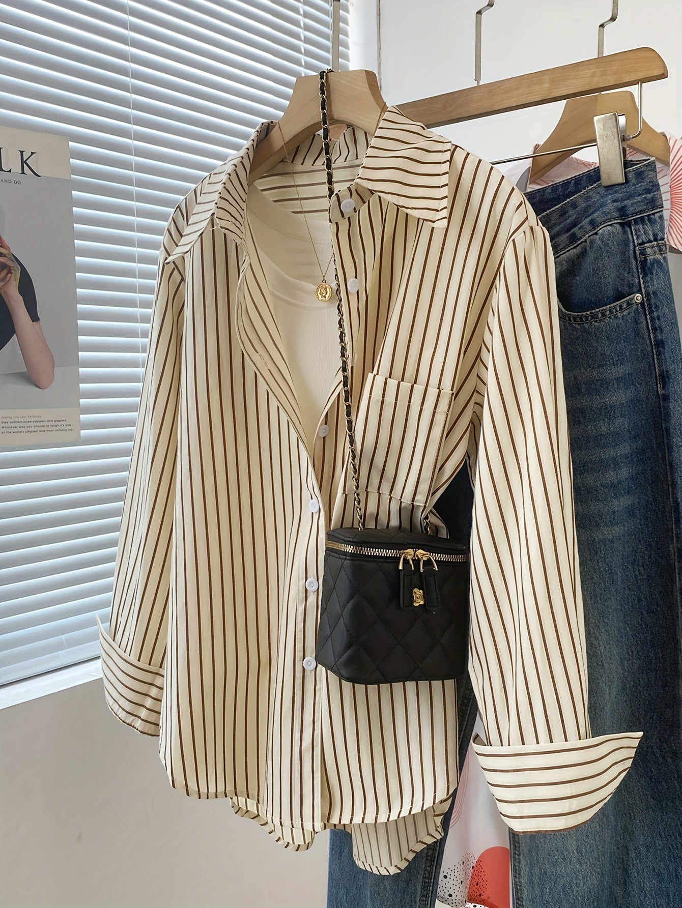 Striped blend shirt for women, with loose fit and ruffled hem detail. French-inspired chic look, perfect for casual wear.