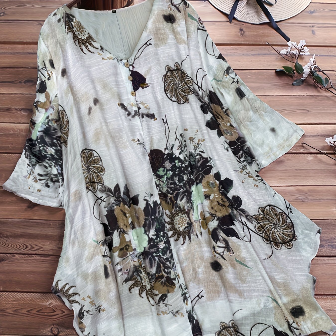 Women's plus size casual top with floral print, short sleeves, V-neck, and asymmetrical hem.