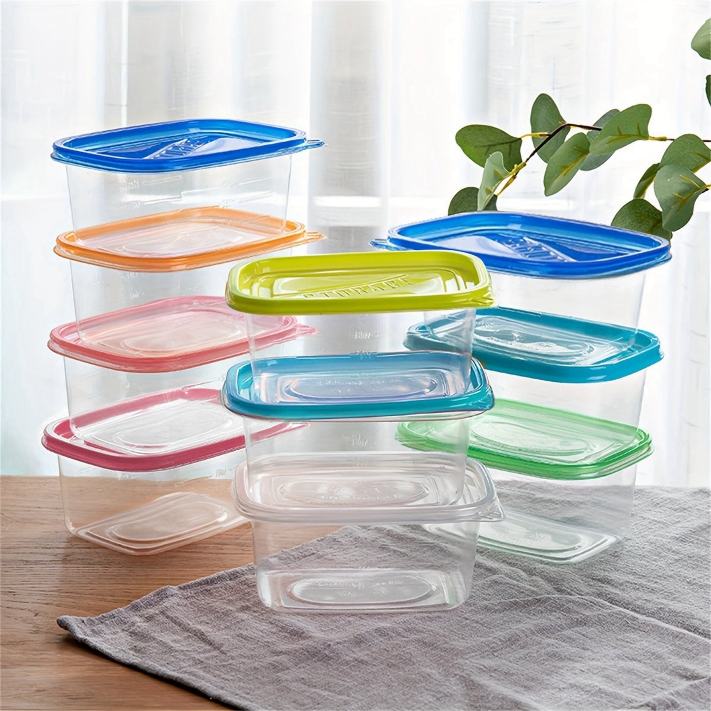 Pack of ten 24-ounce clear plastic meal prep containers that are safe for use in the microwave and dishwasher. These rectangular lunch boxes come with lids in random colors and are reusable.