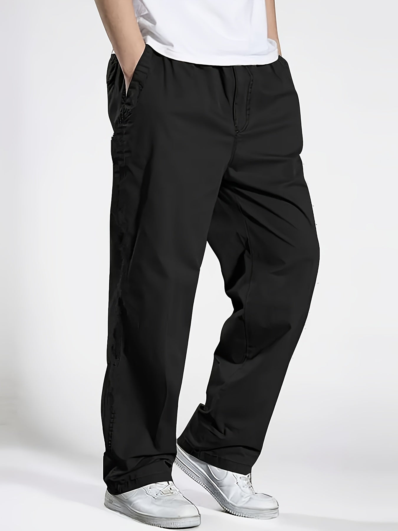 Men's slim fit casual pants with pockets, mid-rise drawstring waist, and breathable polyester fabric for spring/fall wear.