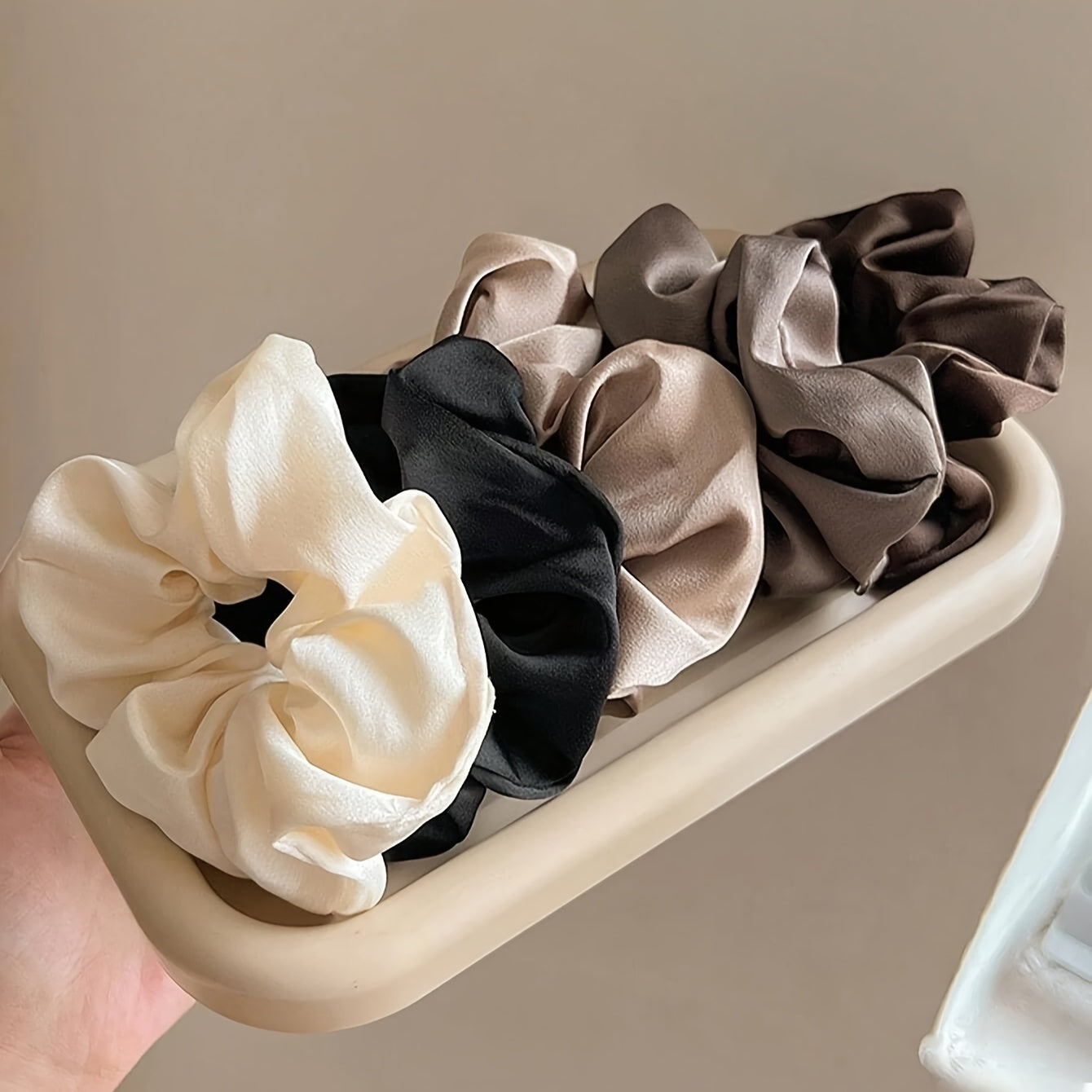 5 elegant and versatile hair scrunchies in classic black, white, and brown suited for all ages.