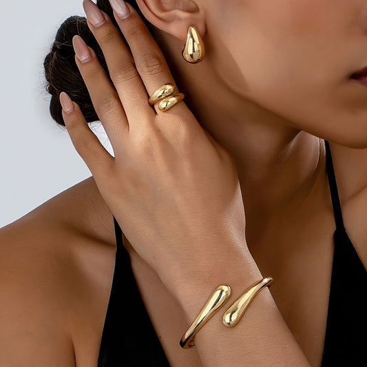 A set of women's jewelry, including earrings, a ring, and a bracelet with a spring design, ideal for everyday elegance.