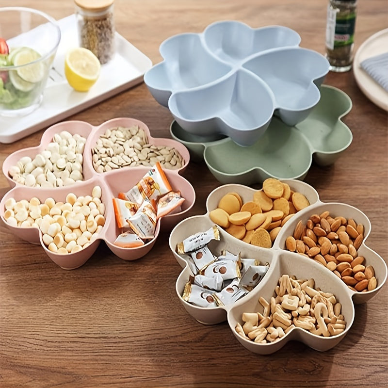 Heart-shaped party snack tray with 4 compartments, perfect for serving nuts, candy, fruit, and other snacks. Made of reusable plastic in blue, green, beige, and pink colors.