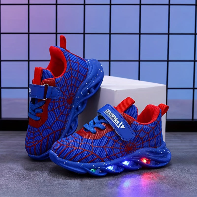 Durable rubber-soled boys' LED sneakers in red and blue with spider web design, breathable mesh, and hook-and-loop closure for casual wear and playtime.