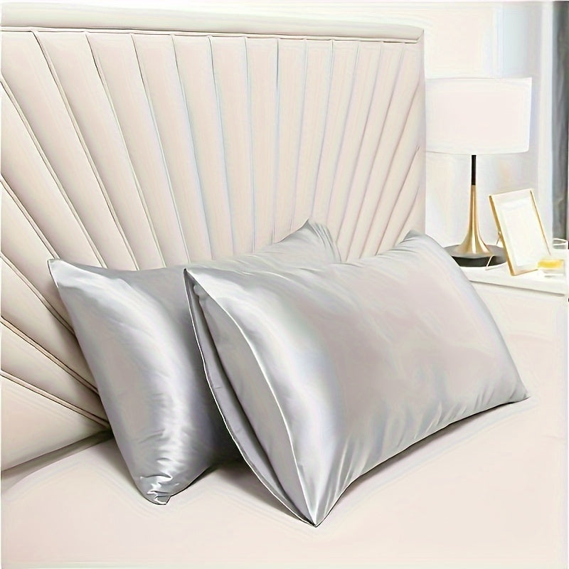 Two luxurious silky soft pillowcases with breathable and skin-friendly cooling feel. Solid color with envelope closure. Machine washable. Set of two.