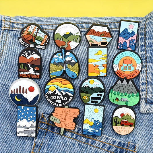 A set of 16 adventure-themed plastic brooch pins featuring travel and nature inspired designs such as trees, rivers, mountains, sun, car, and tent motifs. Perfect for backpack accessories, this holiday gift pin set is sure to inspire any nature lover.