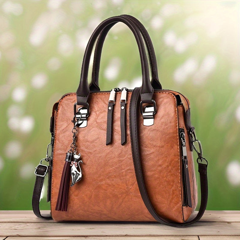 Spacious crossbody bag in vintage faux leather with tassel detail, zip closure, and multiple color options for women.