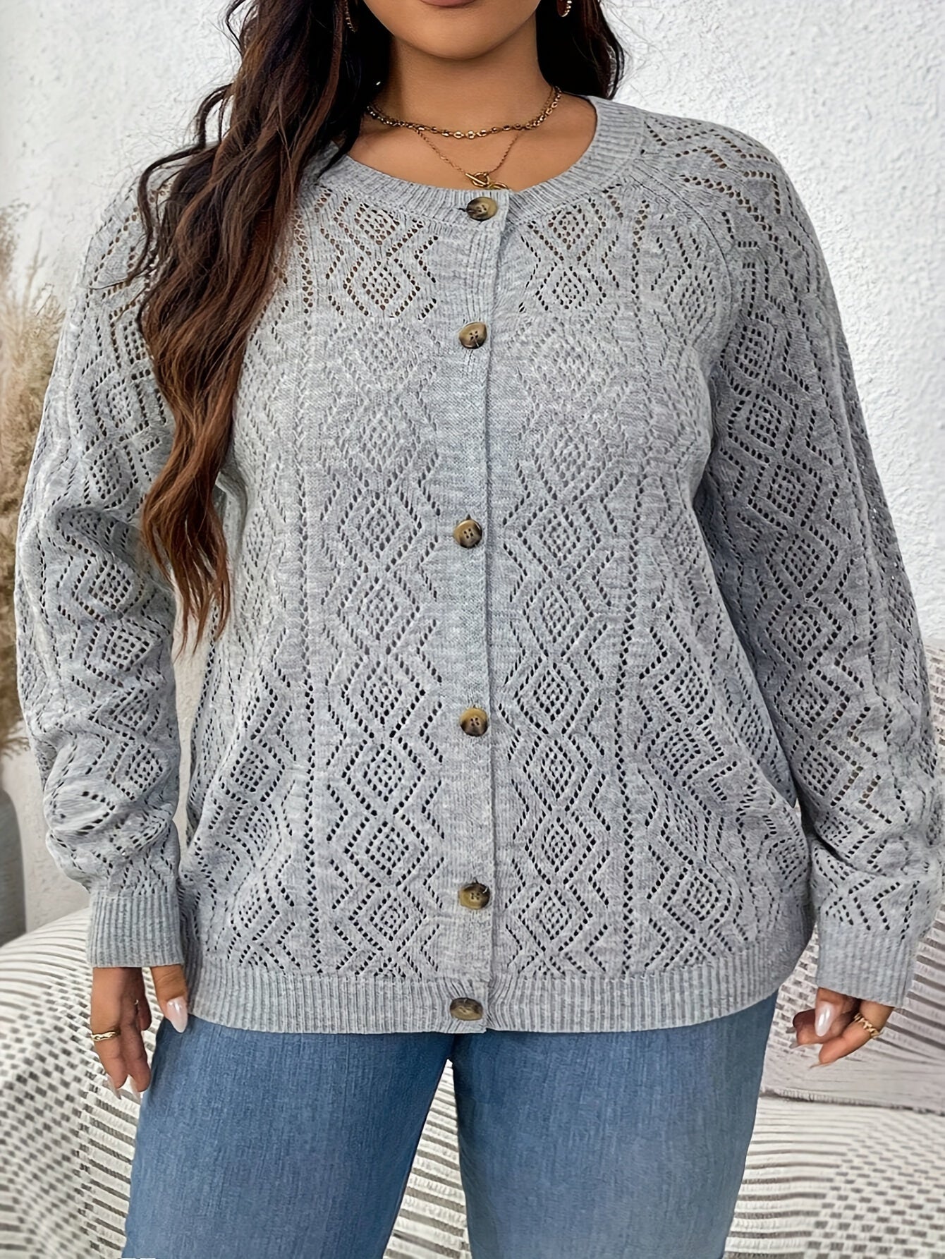 Plus size cable knit cardigan with button front, perfect for fall and winter.