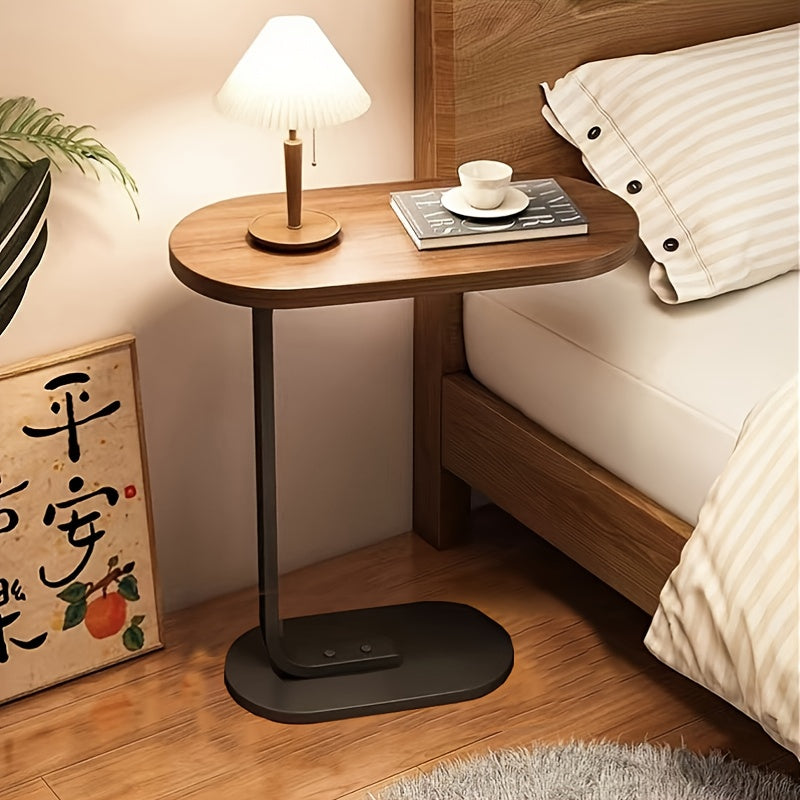 Modern C-shaped sofa side table made of walnut wood and iron, with a sturdy black frame. Compact and durable design suitable for various spaces.