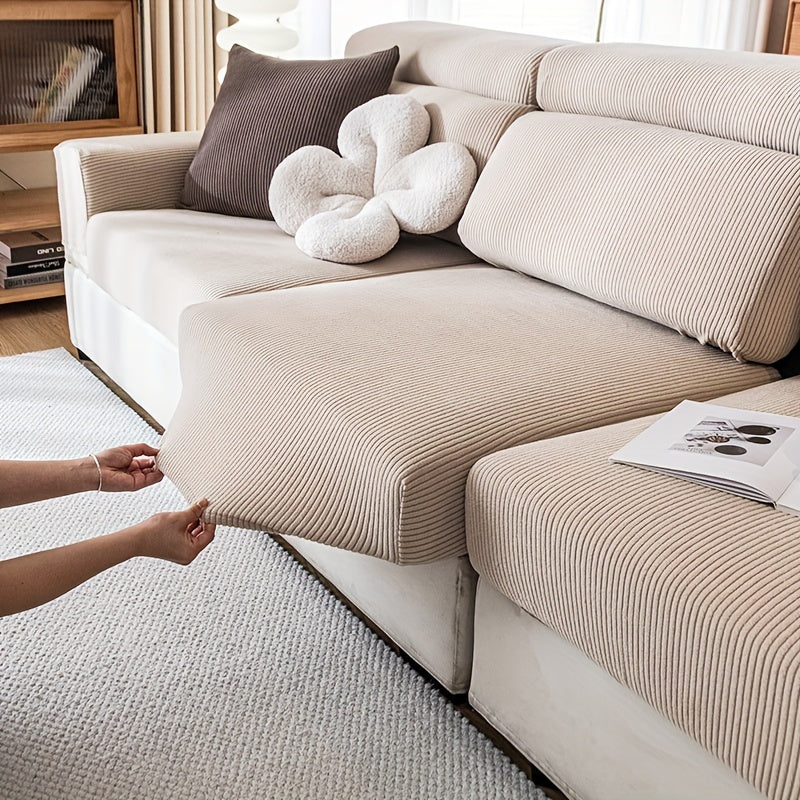 Stretchable polyester sofa cover with elastic band, pet-friendly polar fleece material, machine washable, fits armchair to sectional sofas, home decor slipcover for furniture.