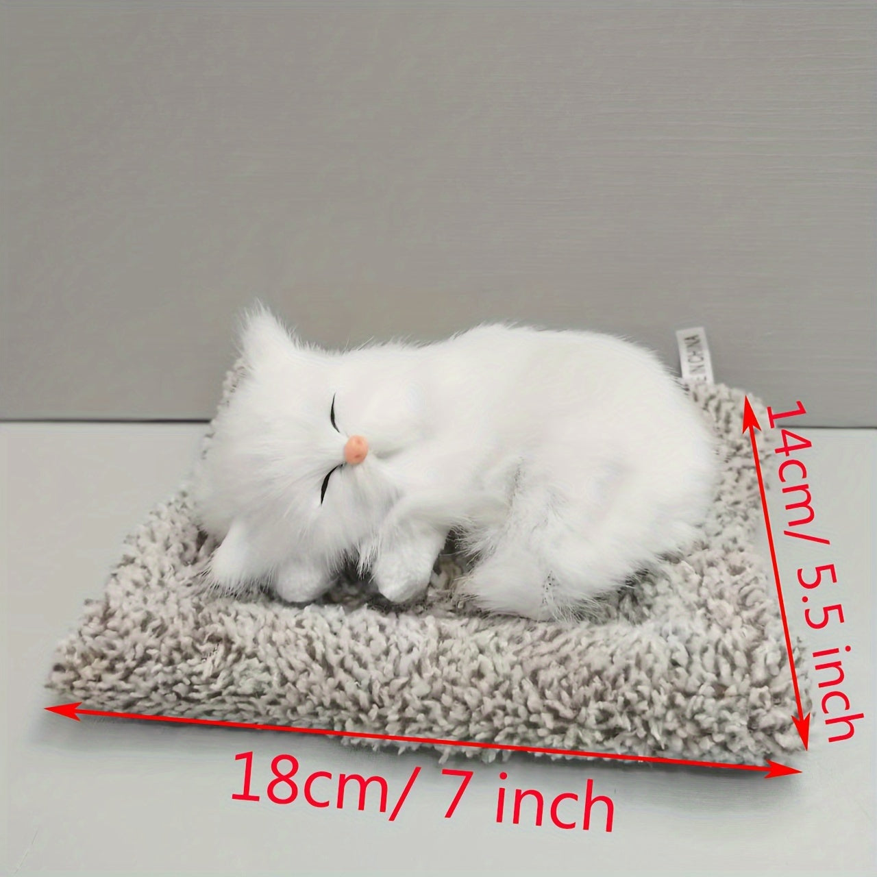 Fluffy sleeping cat figurine.