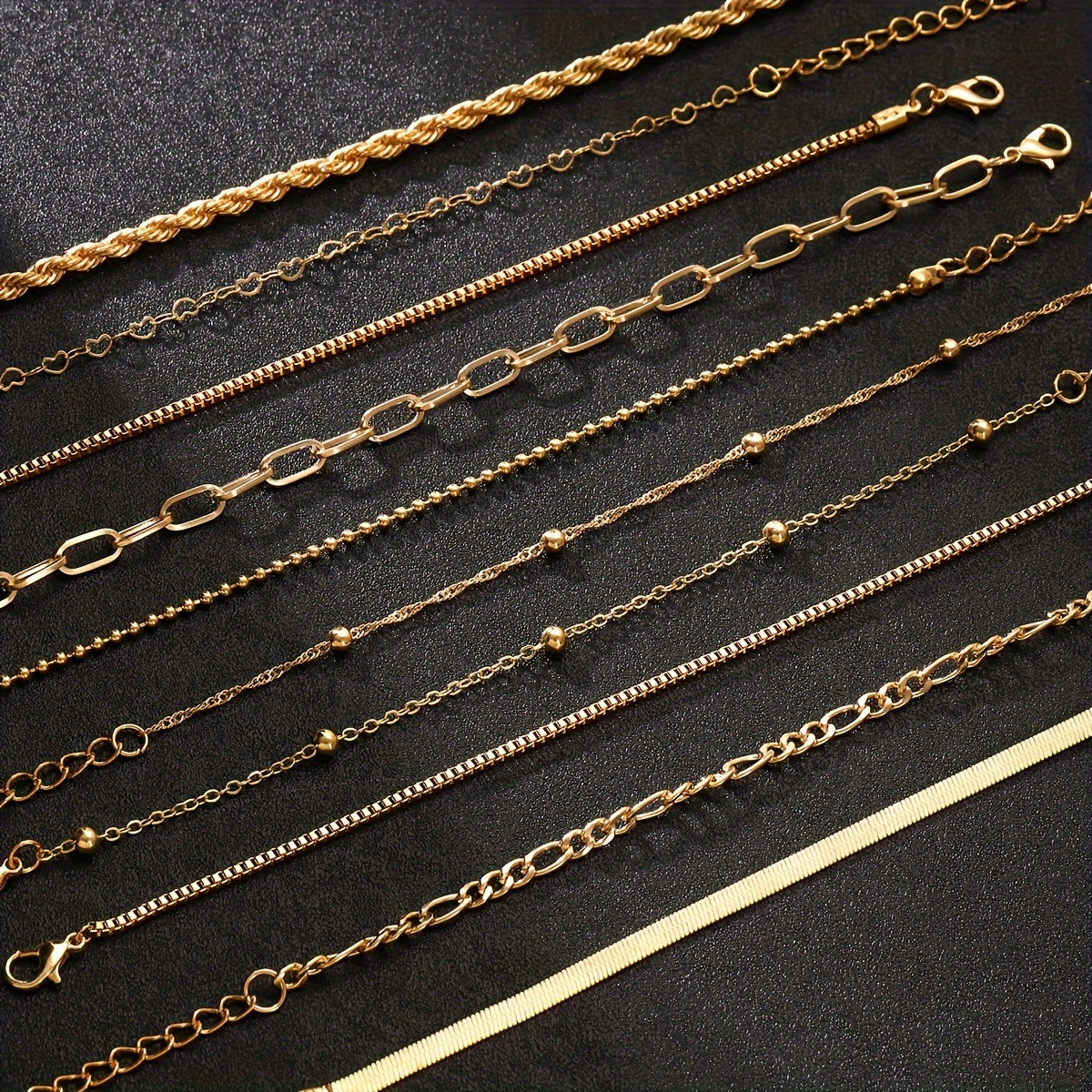 Set of 10 elegant golden-toned bracelets with multi-layer designs and heart charms, ideal for daily wear or parties.