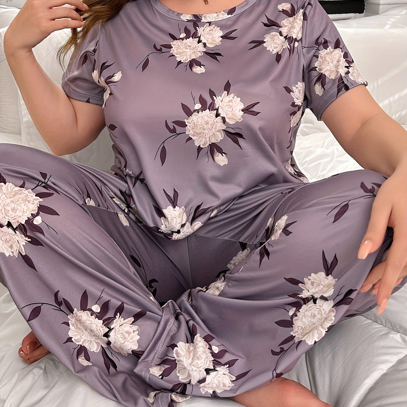 Plus size floral print pajama set for women, including short sleeve top and pants.