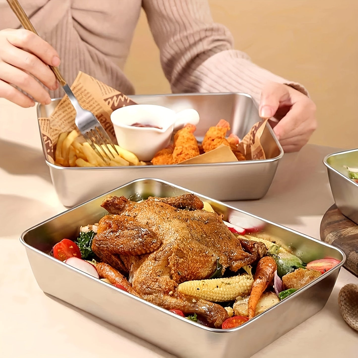 One or two pieces of a household kitchen baking pan made of thickened stainless steel, complete with a lid.